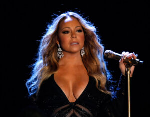 File- This May 27, 2014, file photo shows Mariah Carey performing on stage during the World Music Awards in Monaco. Carey wanted Las Vegas to know there's a new girl in town. The pop icon arrived to cheering screams at Caesars Palace Monday, April 27, 2015, in a classic 1936 pink convertible trailing behind 18 mobile billboards bearing the titles of her number one hits including "Always be my baby" from 1996 and "Heartbreaker" from 1999. The gladiator-clad men took it from there, carrying Carey through the casino on a platform fit for Cleopatra. (AP Photo/Claude Paris, File) ORG XMIT: NY112